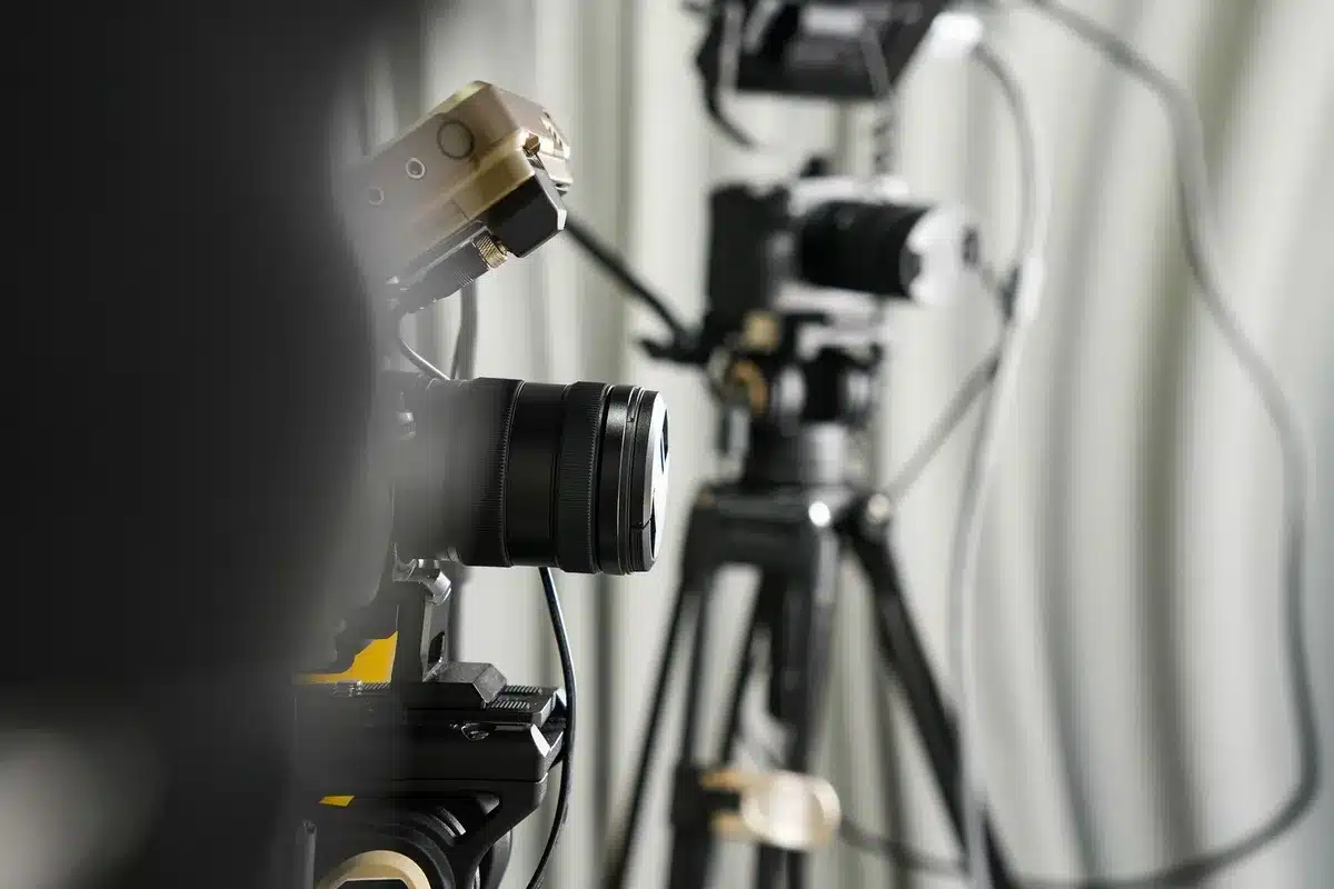 Dispositif téléprompteur avec vitre semi-réfléchissante devant la caméra pour aligner le regard avec l'objectif.