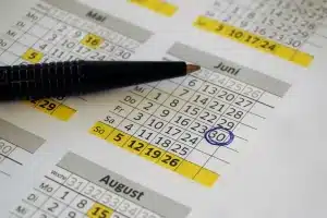 Calendrier marquant une échéance de 15 ans avec documents financiers et stylo sur un bureau