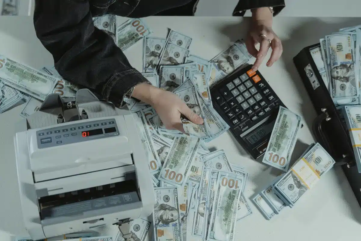 Two anonymous people reviewing a printed mortgage offer at a bright kitchen table with keys on the table