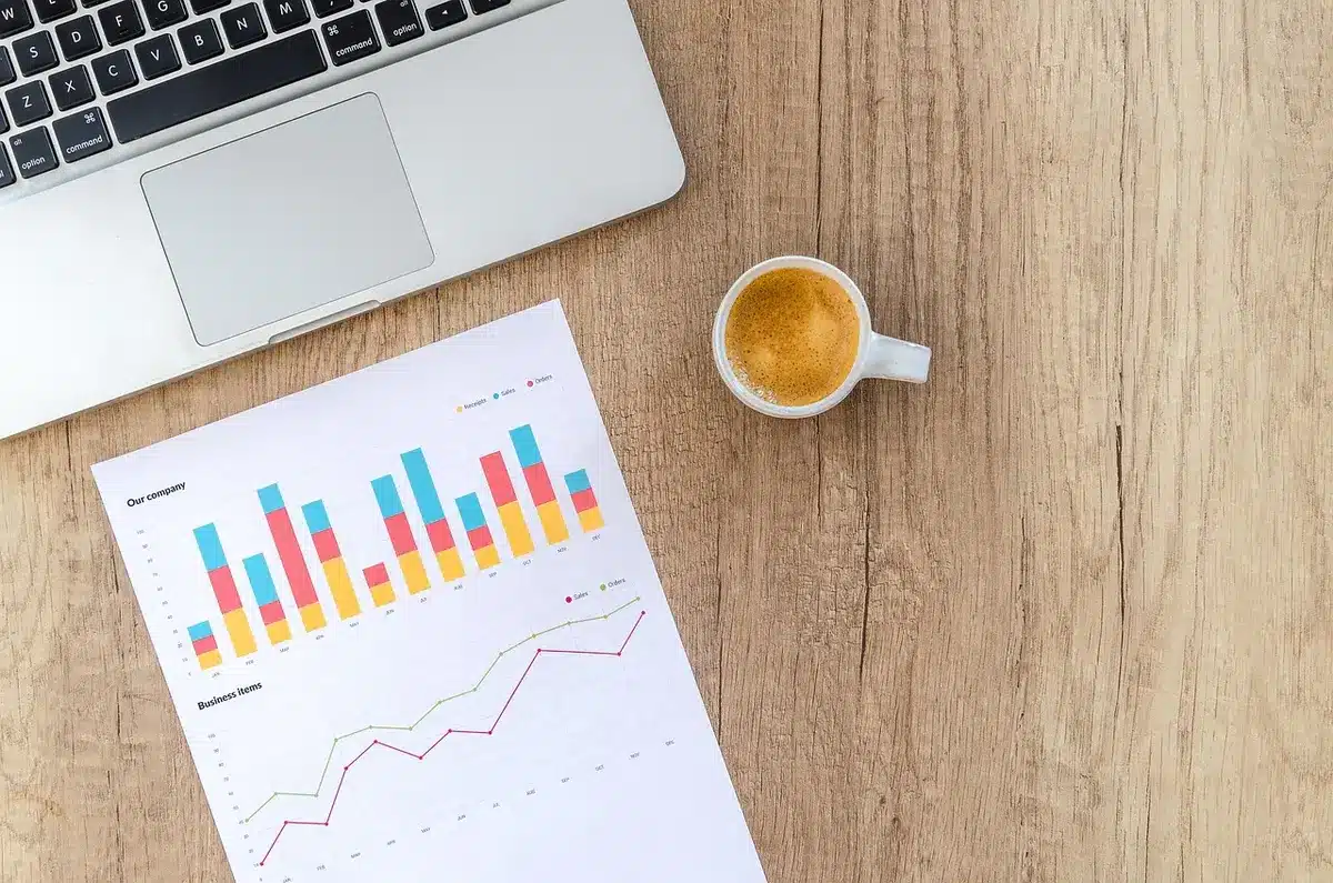 Documents économiques et graphiques sur un bureau éclairé par la journée
