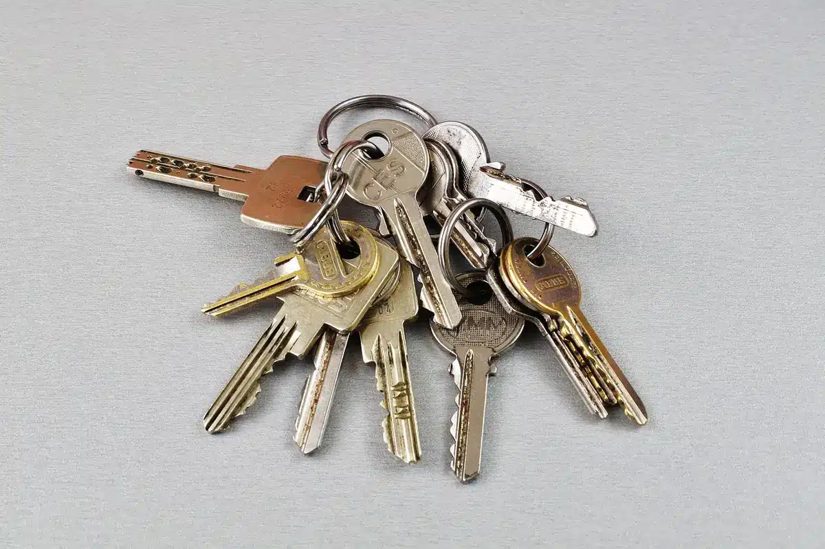set of anonymous hands exchanging keys over a small table with a checklist