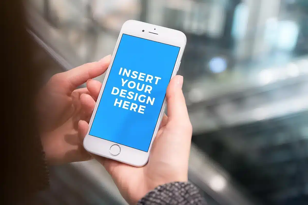 Close-up of anonymous hands adjusting a bank app on a smartphone while a printed tax notice lies nearby