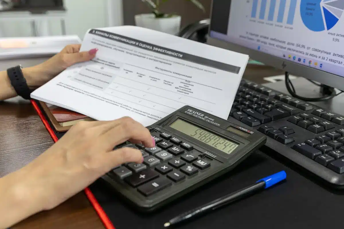 Documents de paie et calculatrice sur un bureau en plein jour