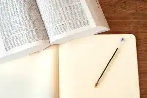 Personne anonyme examinant des documents de formation près d'une fenêtre en journée