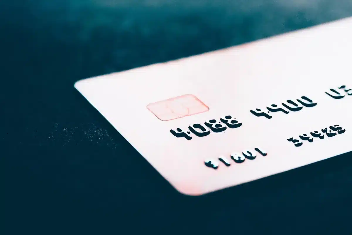 Close-up of anonymous hands on a smartphone showing a payment confirmation screen near a printed tax notice